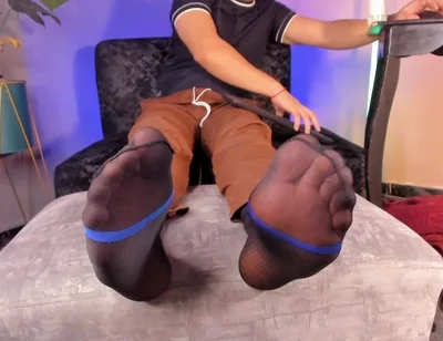 College Teacher Relaxes on the Couch at Home with His Feet on the Furniture so He Can Adore Them