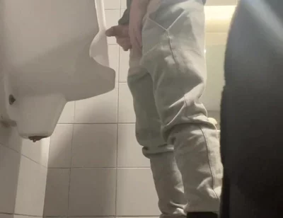 2 Boys in Sneakers Having Fun at Public Toilets' Urinal