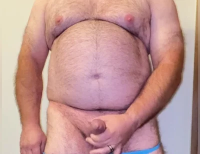 Anal Steve in His Blue Thong Showing off His Bear Body and Cock, with a Cock Ring on and Showing His Massive Butt Plug