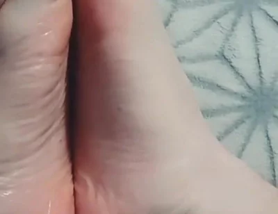 Guy Gently Massages His Feet with Oil